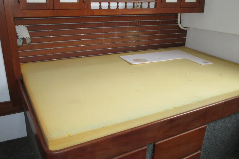 Slide: The Image of 1979 Roughwater 41 interior with wooden cabinetry and yellow foam mattress. - 9