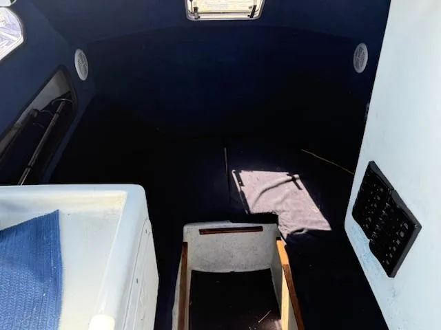 Slide: The Image of Interior of 2007 Radon Signature 26 boat, featuring dark cabin and control panel. - 10