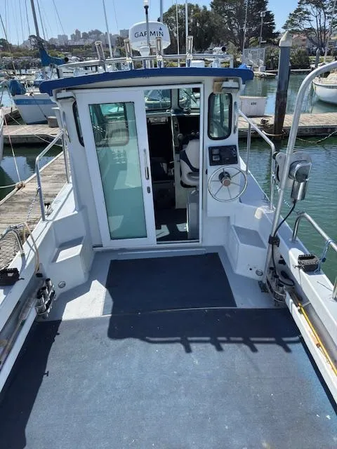 Slide: The Image of 2007 Radon Signature 26 boat docked at marina, featuring spacious deck and cabin. - 11