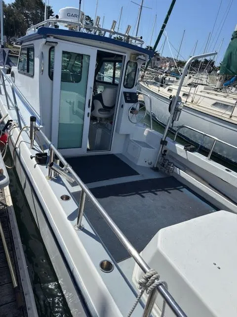 Slide: The Image of 2007 Radon Signature 26 boat docked, featuring spacious deck and cabin. - 17