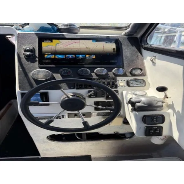 Slide: The Image of Boat cockpit of 2007 Radon Signature 26 with steering wheel and navigation display. - 7