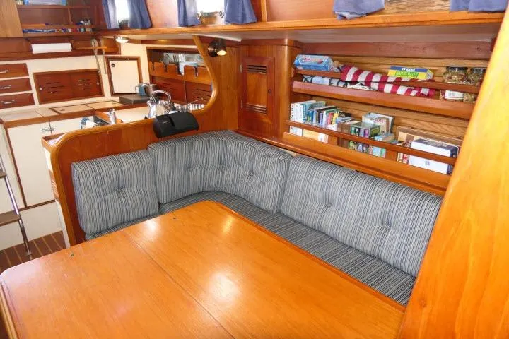 Slide: The Image of Interior of 1982 Cape Dory 36 sailboat with cozy seating and wooden cabinetry. - 11