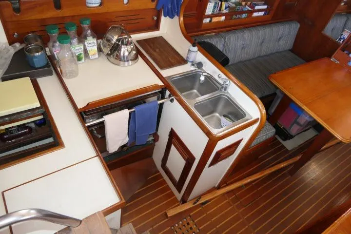Slide: The Image of Interior of 1982 Cape Dory 36 sailboat with kitchen and seating area. - 12