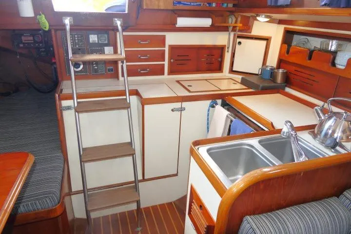 Slide: The Image of 1982 Cape Dory 36 yacht interior with kitchen, sink, and wooden cabinetry. - 17