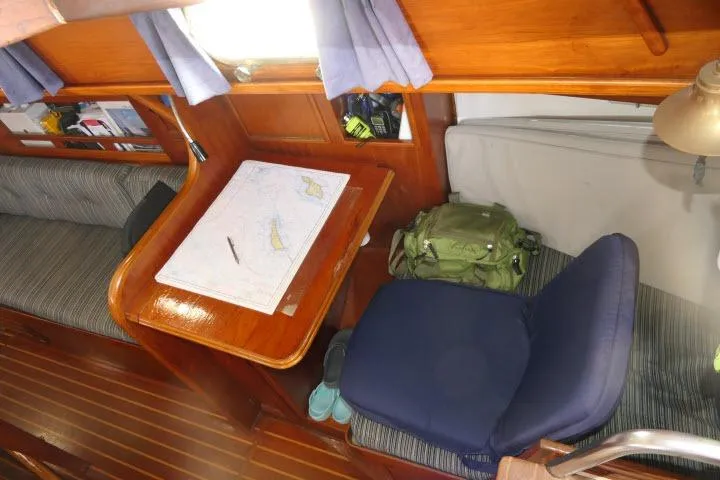 Slide: The Image of Interior of 1982 Cape Dory 36 sailboat with navigation table and seating area. - 18