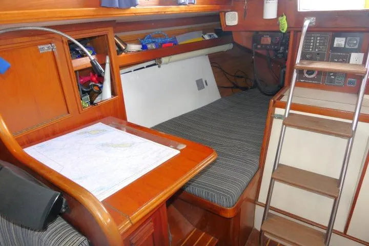 Slide: The Image of 1982 Cape Dory 36 interior with navigation station, chart table, and cozy berth. - 20