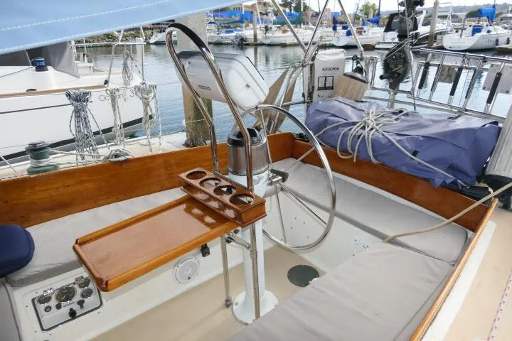 Slide: The Image of Cockpit of a 1982 Cape Dory 36 sailboat with wooden accents and steering wheel. - 25
