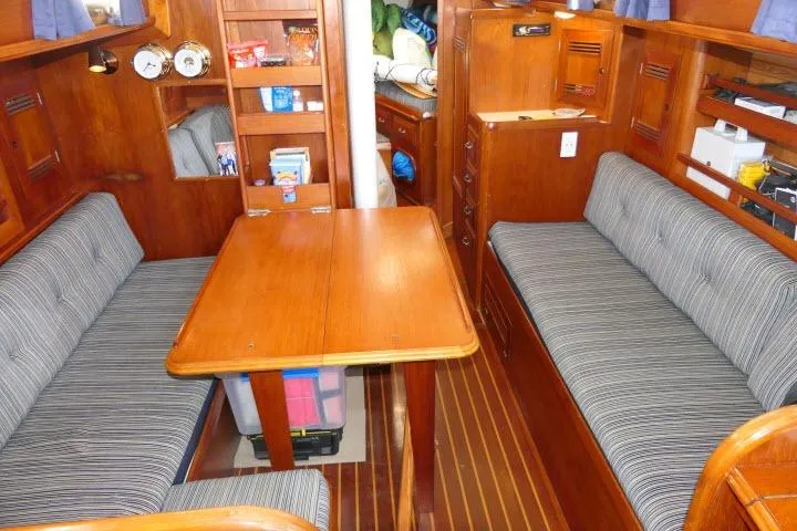 Slide: The Image of Interior of 1982 Cape Dory 36 sailboat with wooden furnishings and striped upholstery. - 3