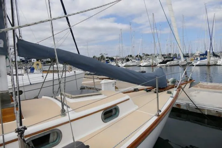 Slide: The Image of 1982 Cape Dory 36 sailboat docked at a marina with other boats. - 34