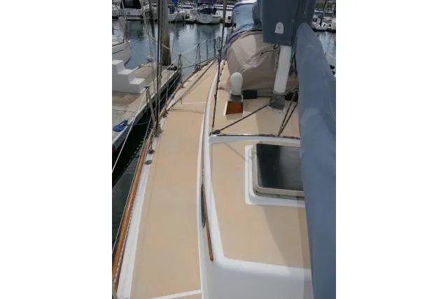 Slide: The Image of 1982 Cape Dory 36 sailboat deck view at marina, showcasing clean lines and classic design. - 36
