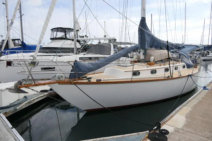 Slide: The Image of 1982 Cape Dory 36 sailboat docked at marina, covered sails, classic design. - 41