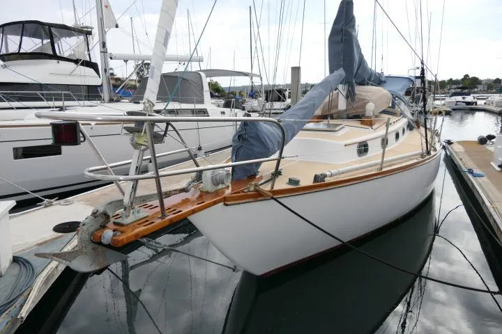Slide: The Image of 1982 Cape Dory 36 sailboat docked in a marina, featuring classic design and wooden accents. - 42
