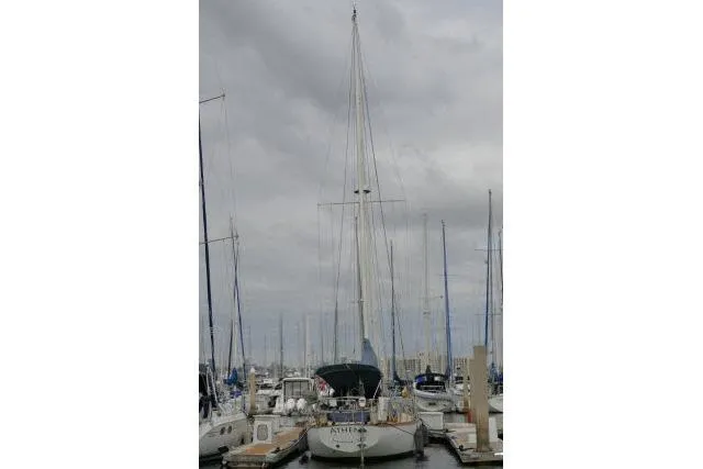 Slide: The Image of 1982 Cape Dory 36 sailboat docked at a marina under cloudy skies. - 44