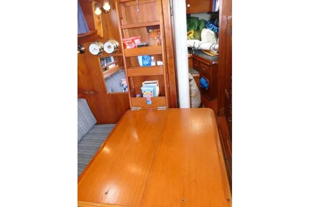 Slide: The Image of Interior of 1982 Cape Dory 36 sailboat with wooden table and shelves. - 5