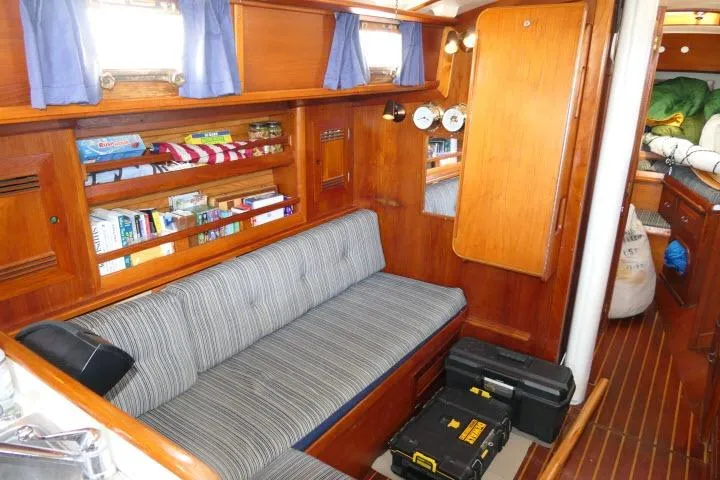 Slide: The Image of Interior of 1982 Cape Dory 36 sailboat with cozy seating and wooden cabinetry. - 6