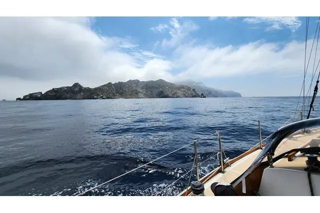 Slide: The Image of Sailing near rocky coastline on 1982 Cape Dory 36 under blue sky. - 61
