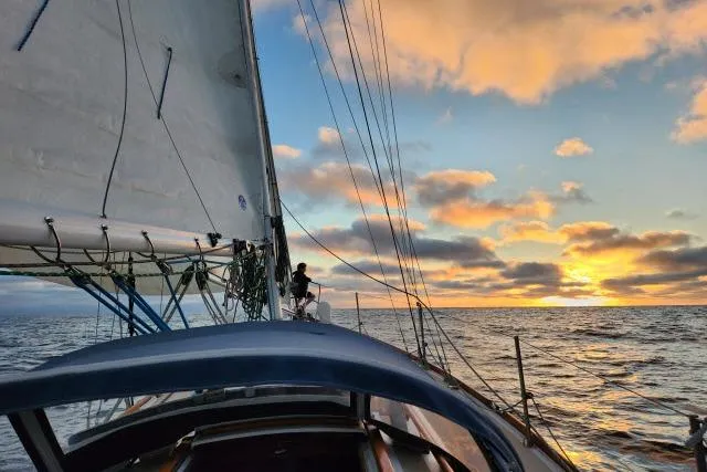 Slide: The Image of Sailing Cape Dory 36 at sunset, 1982 model, on open ocean waters. - 64