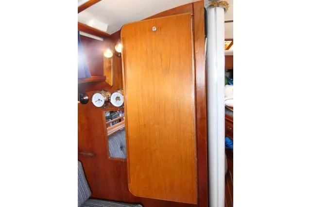 Slide: The Image of Interior of 1982 Cape Dory 36 sailboat with wooden cabinetry and nautical instruments. - 7