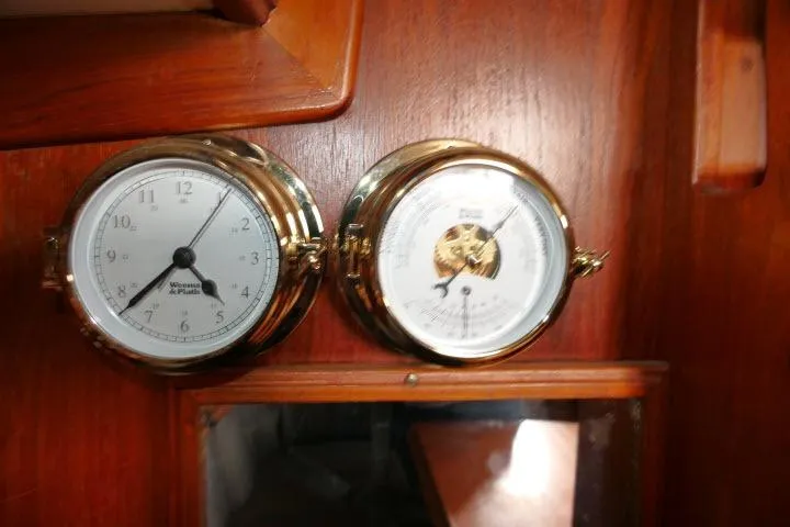 Slide: The Image of Brass clock and barometer on 1982 Cape Dory 36 wooden interior. - 8