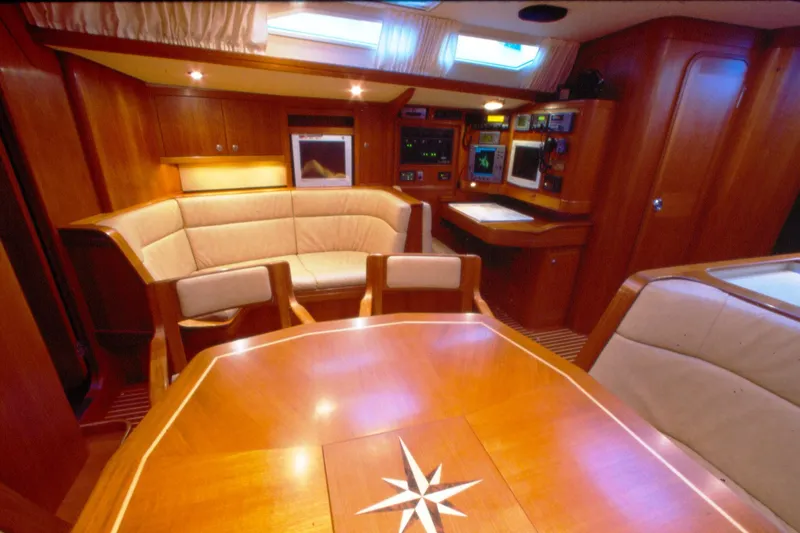 Slide: The Image of Luxurious interior of a 2001 Baltic 52 yacht with elegant wood finish and seating area. - 10