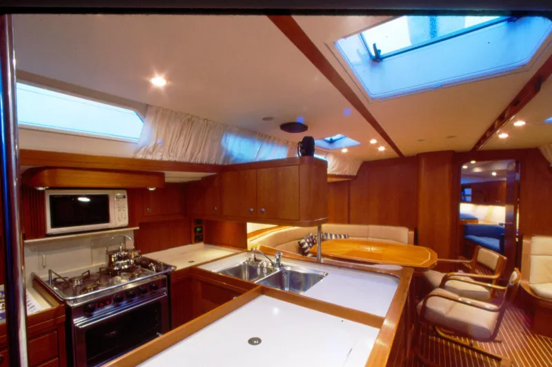 Slide: The Image of Luxurious interior of a 2001 Baltic 52 yacht featuring a modern kitchen and cozy seating area. - 12