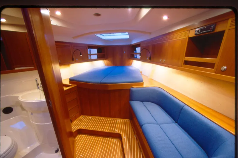 Slide: The Image of Luxurious interior of a 2001 Baltic 52 yacht with wood finish and blue upholstery. - 8