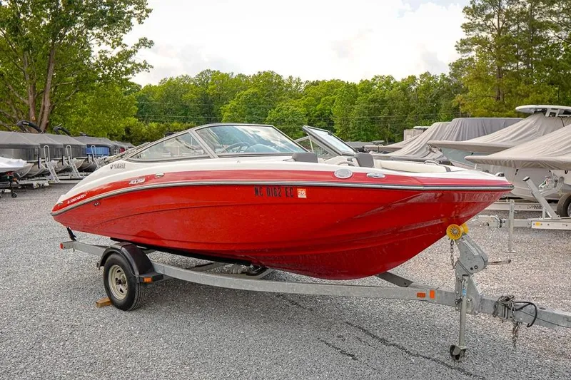 The Image of 2015 Yamaha Boats SX192, red, on trailer in outdoor setting. - 1