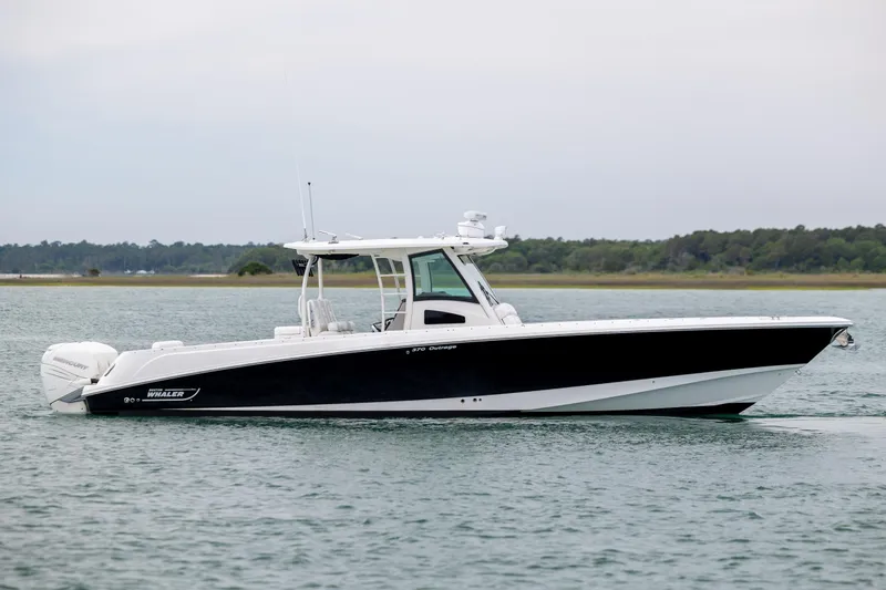 Slide: The Image of 2017 Boston Whaler 370 Outrage boat on calm water, side view. - 10