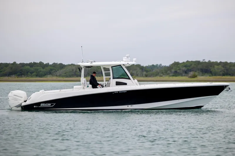 Slide: The Image of 2017 Boston Whaler 370 Outrage boat cruising on calm water. - 11