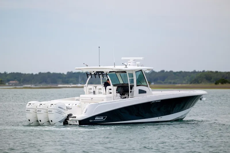 Slide: The Image of 2017 Boston Whaler 370 Outrage boat cruising on calm waters. - 13