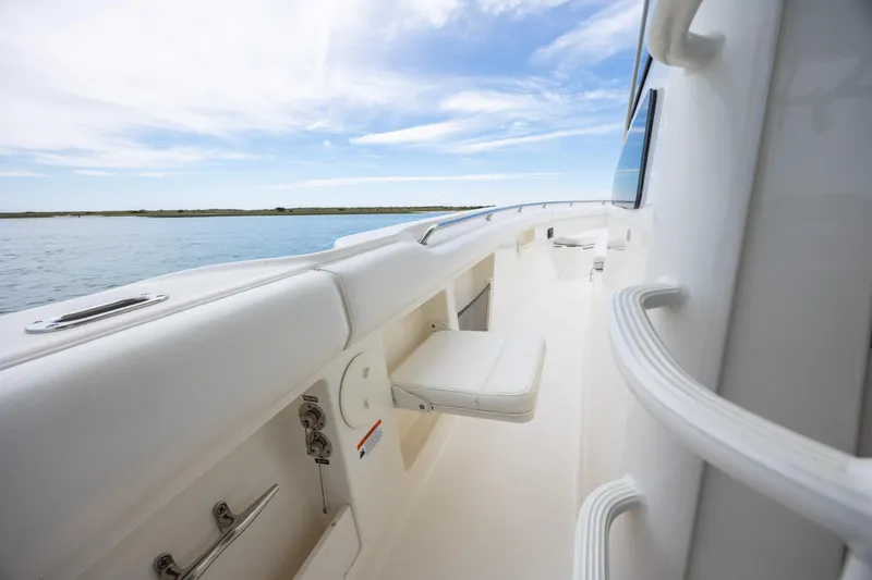 Slide: The Image of 2017 Boston Whaler 370 Outrage boat deck with seating, overlooking calm waters. - 41