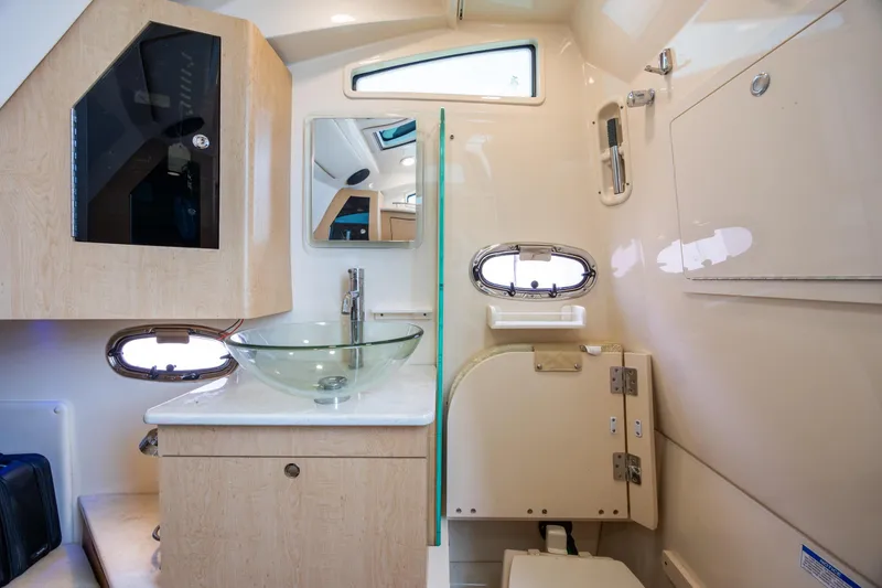 Slide: The Image of Luxurious bathroom interior of 2017 Boston Whaler 370 Outrage with glass sink and modern fixtures. - 44