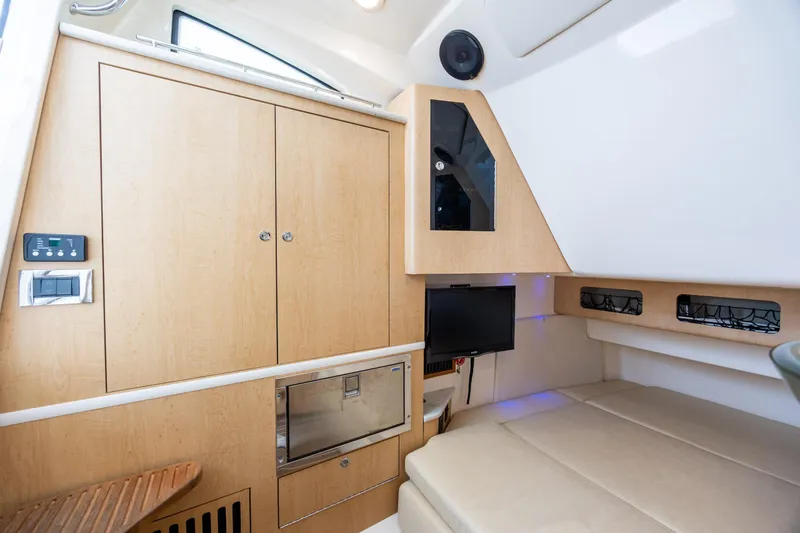 Slide: The Image of Interior cabin of 2017 Boston Whaler 370 Outrage with wood cabinetry and seating. - 45