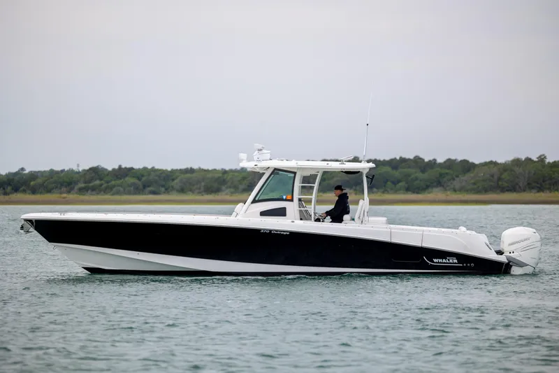 Slide: The Image of 2017 Boston Whaler 370 Outrage boat cruising on calm water. - 7