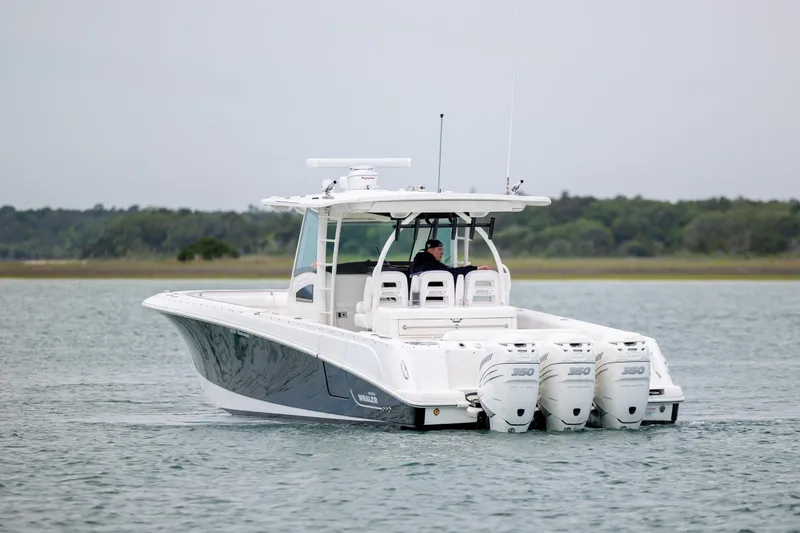 Slide: The Image of 2017 Boston Whaler 370 Outrage boat with triple engines on calm water. - 9