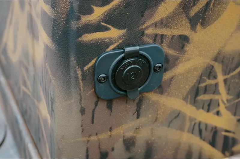 Slide: The Image of 12V marine outlet on 2026 G3 Gator Tough 18 CC boat with camouflage design. - 13