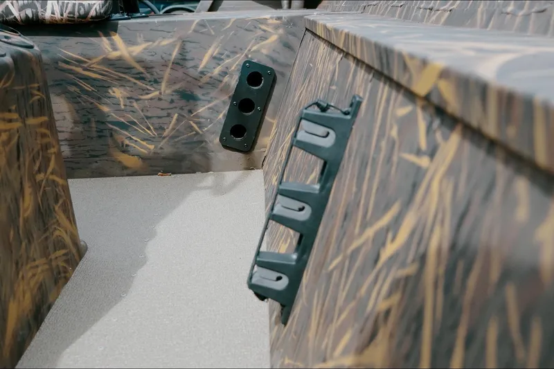Slide: The Image of 2026 G3 Gator Tough 18 CC boat interior with camouflage design and rod holders. - 3