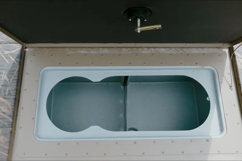 Slide: The Image of Livewell compartment of 2026 G3 Gator Tough 18 CC boat, open and empty. - 5