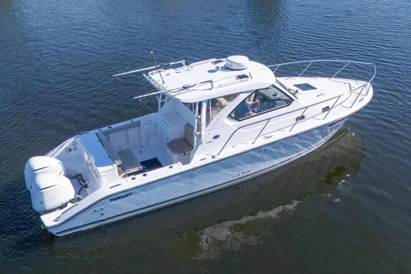 The Image of 2018 Pursuit OS 325 Offshore boat on calm water, aerial view. - 0