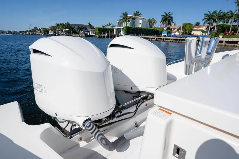Slide: The Image of 2018 Pursuit OS 325 Offshore boat with dual Yamaha outboard engines on a sunny day. - 12