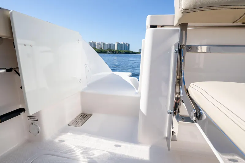 Slide: The Image of 2018 Pursuit OS 325 Offshore boat interior with water view and city skyline. - 14