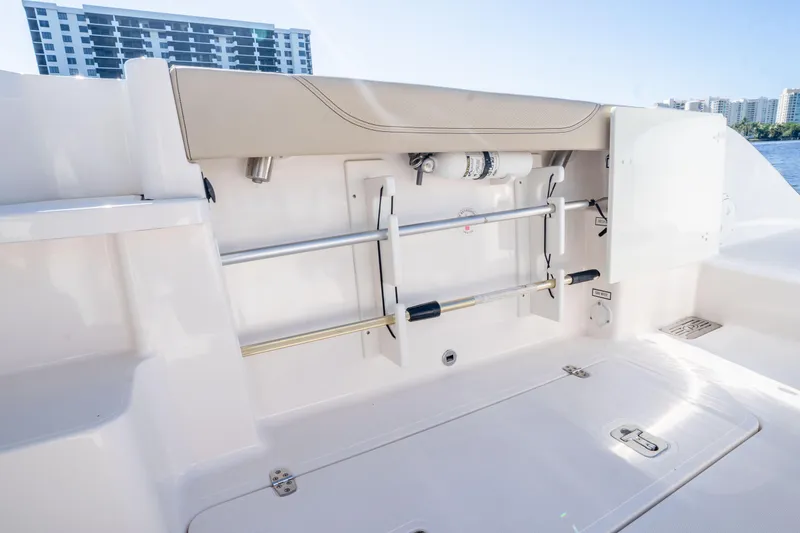 Slide: The Image of 2018 Pursuit OS 325 Offshore boat interior with storage compartment and safety equipment. - 19