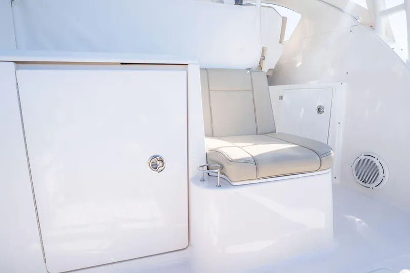 Slide: The Image of 2018 Pursuit OS 325 Offshore interior seating with storage compartments. - 21