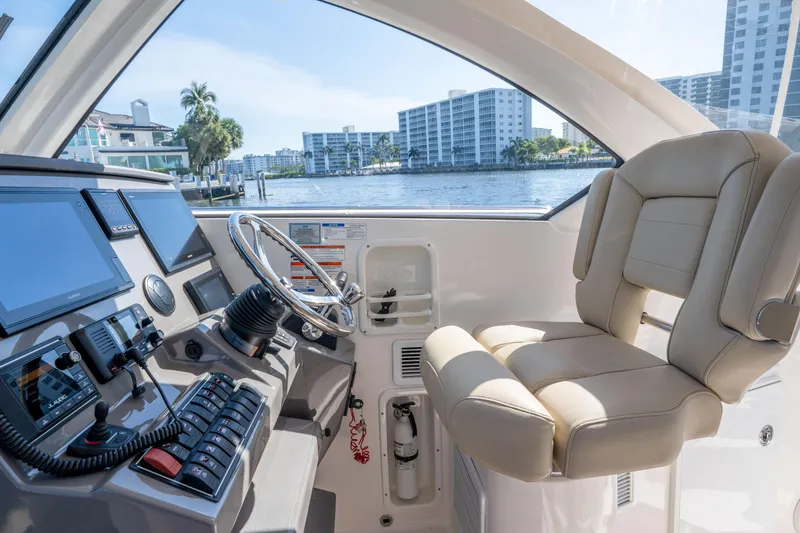 Slide: The Image of Helm of 2018 Pursuit OS 325 Offshore boat with modern controls and waterfront view. - 24
