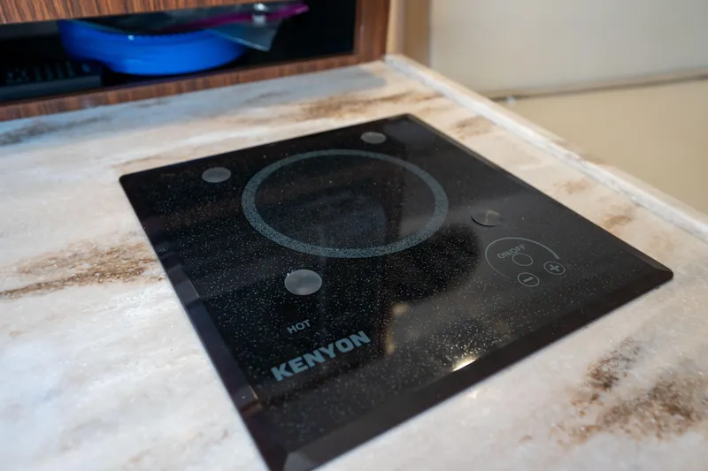 Slide: The Image of Kenyon cooktop on 2018 Pursuit OS 325 Offshore boat's countertop. - 31