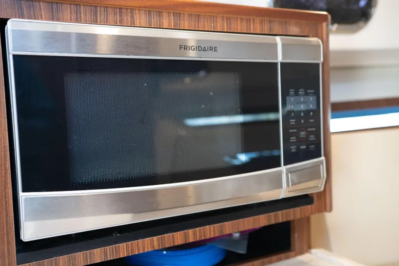 Slide: The Image of Frigidaire microwave in 2018 Pursuit OS 325 Offshore boat kitchen. - 32