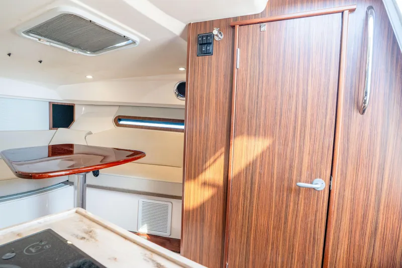 Slide: The Image of Interior of 2018 Pursuit OS 325 Offshore boat with wood finish and seating area. - 34