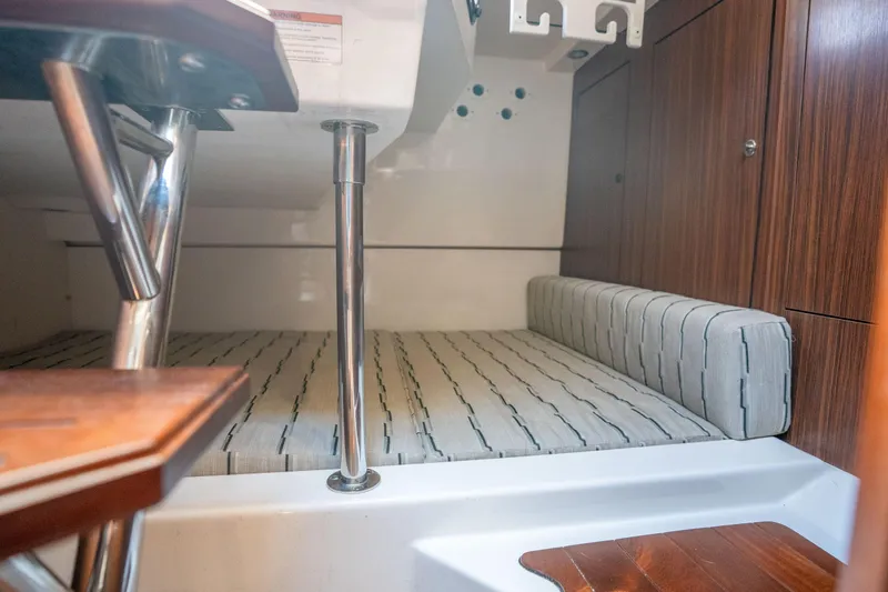 Slide: The Image of Interior cabin of 2018 Pursuit OS 325 Offshore boat with cushioned seating. - 38