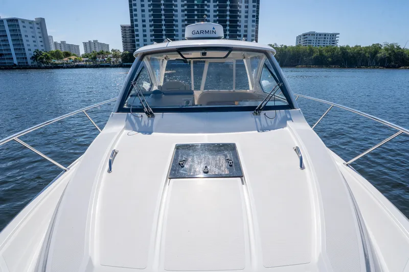 Slide: The Image of 2018 Pursuit OS 325 Offshore boat on water with city skyline background. - 41