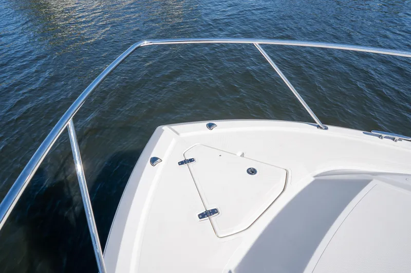 Slide: The Image of Bow of 2018 Pursuit OS 325 Offshore boat on calm water. - 42